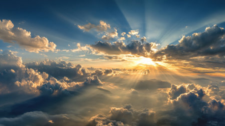 Experience the captivating beauty of a sunrise over clouds, with rays of light shining through the sky, creating a serene and inspirational atmosphere ideal for nature lovers.の素材