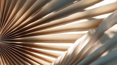 A close-up view of pleated fabric showcases elegant lines and soft natural light. The interplay of shadows adds depth, creating a warm and inviting atmosphere.の素材