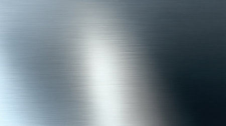 This image features a smooth brushed metal texture with soft gradients and subtle reflections, ideal for modern design projects and industrial themes.の素材