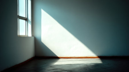 A tranquil scene showcasing a sunbeam filtering through a window in a minimalistic room, creating striking light and shadow patterns on the surfaces.の素材