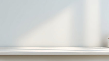 A serene interior scene featuring a minimalist shelf with a single plant, soft shadows, and a bright white wall, perfect for modern decor inspiration or tranquil ambiance.の素材