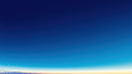 A breathtaking view of a clear blue sky transitioning into warm hues of sunset at the horizon creates a peaceful and tranquil atmosphere for nature lovers and artists.の素材