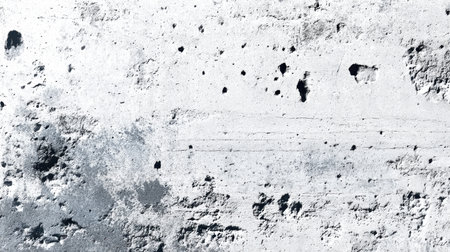This image features a weathered white surface, showcasing cracks, dark speckles, and subtle textures, perfect for backgrounds, artistic designs, and creative projects.の素材