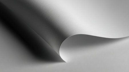 This image features a beautifully curved white paper creating soft shadows, perfect for enhancing artistic designs and minimalist backgrounds in creative projects.の素材