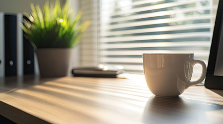 A calm and quiet office desk with a coffee cup, a planner, and a plant, offering space for business-related copy.の素材