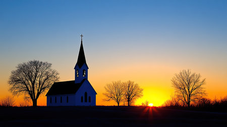 A glowing sunrise behind a silhouette of a church steeple, symbolizing Easter morning hymns.の素材