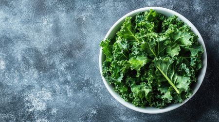 Fresh kale leaves placed in a white ceramic bowl, ready to be added to a salad or smoothie, with ample copy spaceの素材