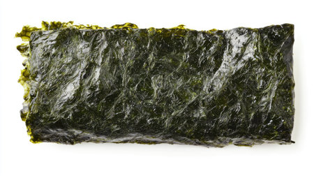 A fresh, uncooked sheet of nori seaweed, isolated on a clean white background for a simple and natural lookの素材