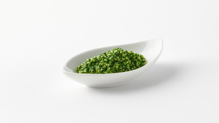 A small portion of wasabi paste in a ceramic dish, isolated on a white background, with bright green tones and smooth texture clearly visibleの素材