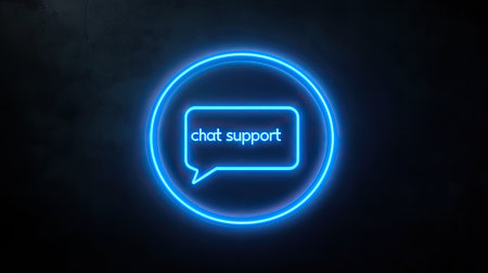 A neon blue chat support icon on a dark background, symbolizing real-time customer interactions.の素材