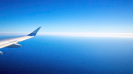 A distant view of an airplane flying over the deep blue Atlantic, with the expansive ocean stretching endlessly, symbolizing the scale of a transatlantic flight.の素材