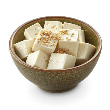 A small bowl of tofu with sesame seeds sprinkled on top, isolated on white.の素材