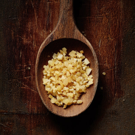 A wooden spoon filled with minced garlic, freshly chopped.の素材