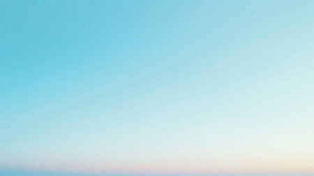A cloudless sky in a gentle blue shade, offering a calm and serene background.の素材