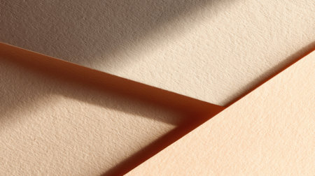 A close-up view of textured paper in soft warm tones, showcasing abstract shapes and gentle shadows to enhance artistic inspiration and design creativity.の素材