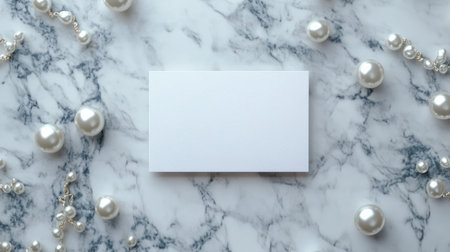 Elegant card on a marble table with scattered pearls and soft natural light for a luxurious look.の素材