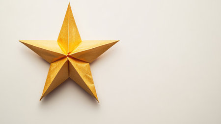 A beautiful origami star in gold, placed centrally on a neutral background, leaving space for a custom text.の素材