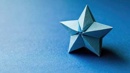 A delicate origami star placed on a subtle gradient background, creating an open space for a personalized note.の素材