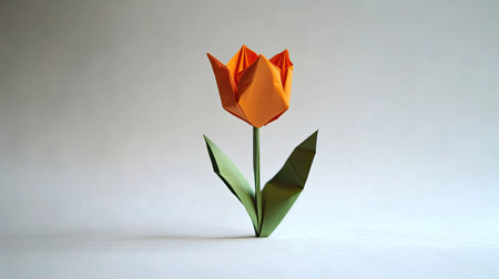 A single origami tulip on a white surface, offering ample space for a personal message or greeting in the center.の素材