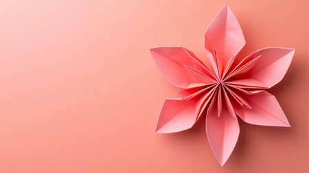 A single origami flower on a soft pastel background, with light shading and ample space for text or greeting in the center.の素材
