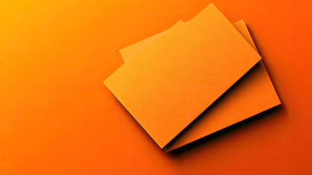 Minimal blank business card on a bold orange background with small geometric cutouts for a modern design.の素材