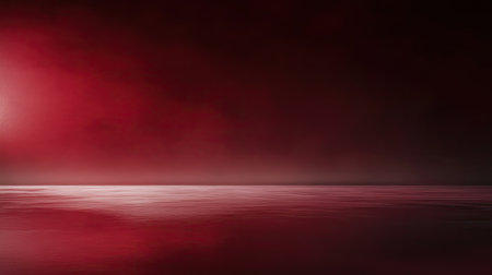 A maroon red background with a soft, reflective surface, providing a luxurious setting for creative content or branding.の素材