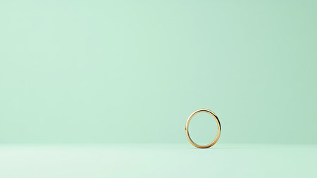 Minimalist design featuring a single gold ring with a diamond accent on a pale green background.の素材