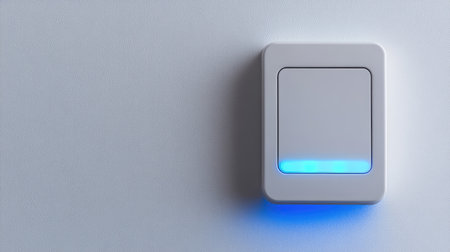 A glowing smart light switch on a clean white wall, symbolizing smart home lighting control. Spacious background for text.の素材