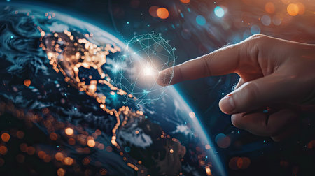 Close-up of a hand pointing to Earth with a Net Zero icon, showcasing commitment to reducing carbon footprint.の素材