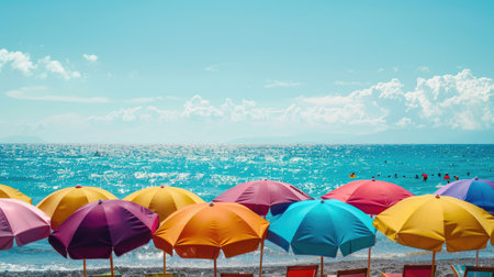 Beach umbrellas in various colors adding a festive touch to the seaside panoramaの素材