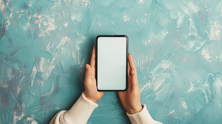 Adult hands presenting smartphone with empty touch screenの素材