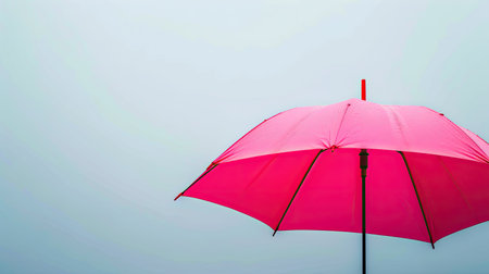 Bright pink umbrella adding a pop of color against a plain backgroundの素材
