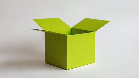 Bright green cardboard box partially folded on a white backgroundの素材