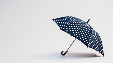 Whimsical polka dot umbrella catching attention on a clean backgroundの素材