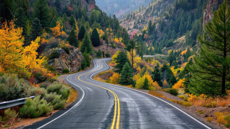 Picturesque asphalt road winding through a forested mountain landscapeの素材