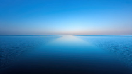 A breathtaking view of a calm ocean under a clear blue sky at dusk, capturing the essence of serenity and tranquility. Ideal for visual relaxation and meditation.の素材