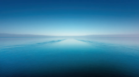 A stunning seascape featuring calm waters under a gradient blue sky, creating a serene and tranquil atmosphere ideal for relaxation and nature appreciation.の素材