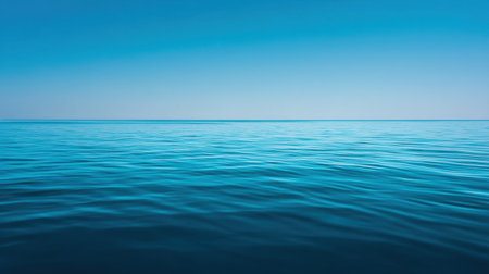 Discover the beauty of a serene ocean surface reflecting a clear blue sky, creating a peaceful atmosphere that invites relaxation and contemplation amidst natureの素材