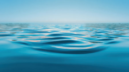 A serene image of calm blue water with gentle ripples and soft sky reflections, perfect for use in meditation, relaxation, or nature-themed projects.の素材