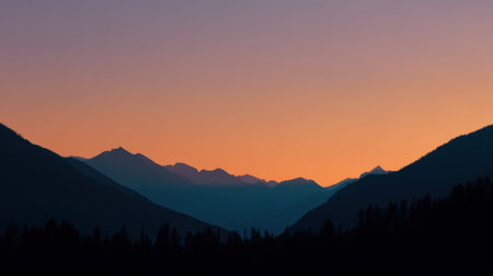 A stunning mountain landscape during dusk showcasing vibrant sunset colors, creating a serene atmosphere with silhouettes of peaks against a gradient sky.の素材