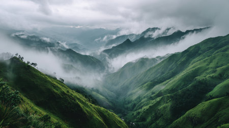 Capture the breathtaking beauty of mist-covered green mountains under a cloudy sky, creating a serene atmosphere that inspires adventure and exploration in nature lovers.の素材