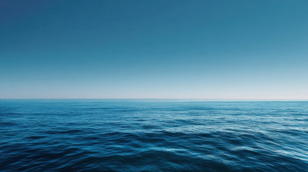 A serene ocean view showcasing endless blue water blending seamlessly with a bright blue sky. This stunning scene captures the essence of tranquility and relaxation.の素材