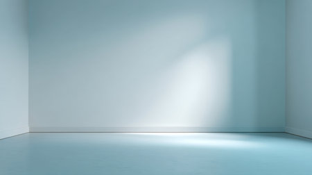 A minimalist empty room featuring smooth light blue walls and floors, bathed in soft natural light, ideal for creating a tranquil atmosphere and inspiring designs.の素材
