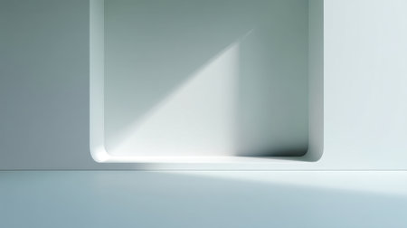 A serene minimalist interior showcases a clean white wall featuring a geometric alcove illuminated by natural light, creating delicate shadows and a calming atmosphere.の素材