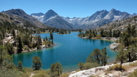 A tranquil lake nestled among tall mountains and dense greenery, offering a peaceful escape for outdoor enthusiasts and photographers looking to capture natural beauty.の素材