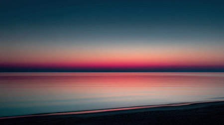 Serene view of a calming ocean at sunset, showcasing a beautiful gradient of colors across the sky and water, creating a peaceful and tranquil atmosphere.の素材
