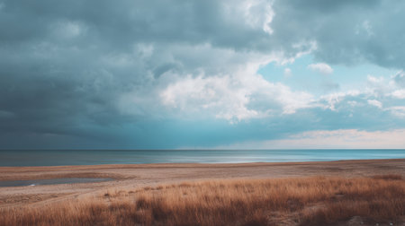 A stunning coastal scene featuring a calm sea under a dramatic sky filled with clouds and soft sunlight, ideal for nature lovers and travel enthusiasts seeking tranquility.の素材