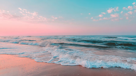 A breathtaking sunset scene featuring gentle ocean waves lapping against a soft sandy beach. The pastel sky reflects nature's tranquility, perfect for relaxation.の素材