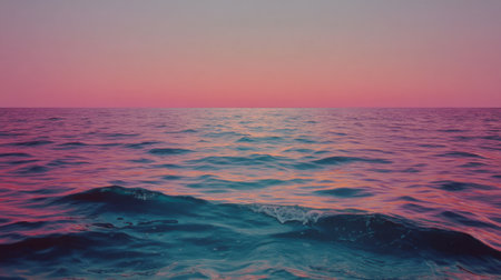 A serene ocean view captures the gentle waves at sunset, with a colorful sky showcasing hues of blue and pink. This image evokes feelings of tranquility and peacefulness.の素材