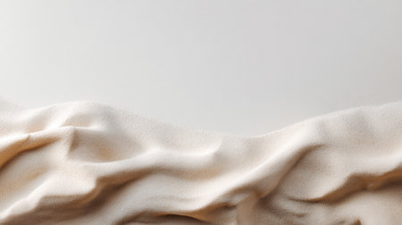 This image showcases a beautifully draped fabric texture in soft beige tones, creating gentle curves and waves against a smooth backdrop, perfect for design inspiration.の素材